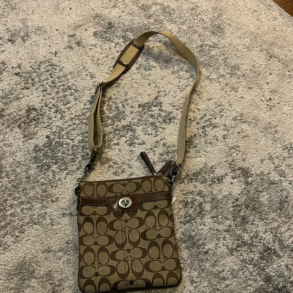 Brown and beige Coach crossbody bag.